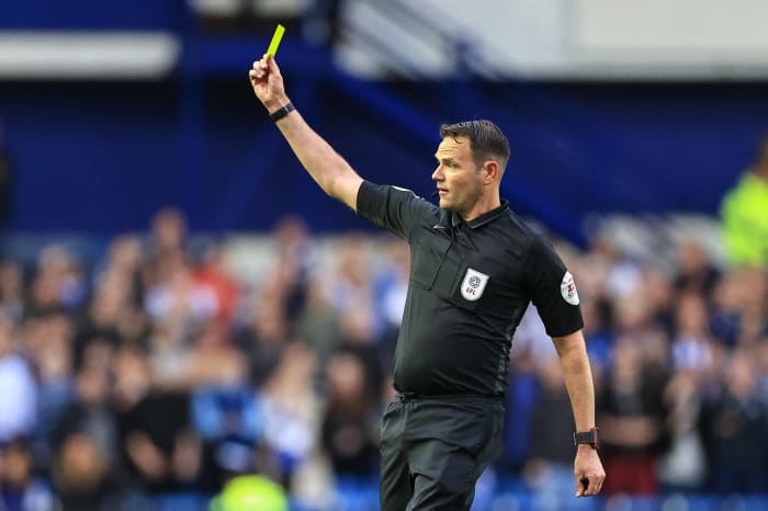 James Linington dishing out a yellow card to Ross Stewart in last season's play-off semi-final against Sheffield Wednesday.